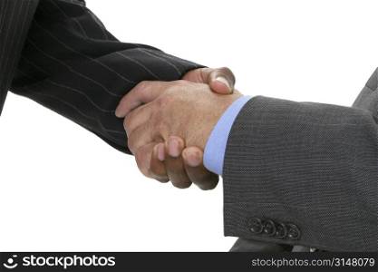 Close-up of businessmen in suits shaking hands.
