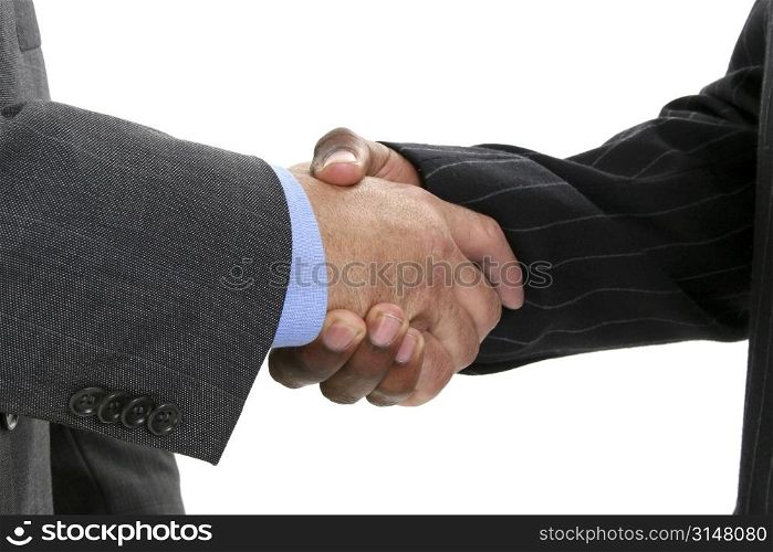 Close-up of businessmen in suits shaking hands.