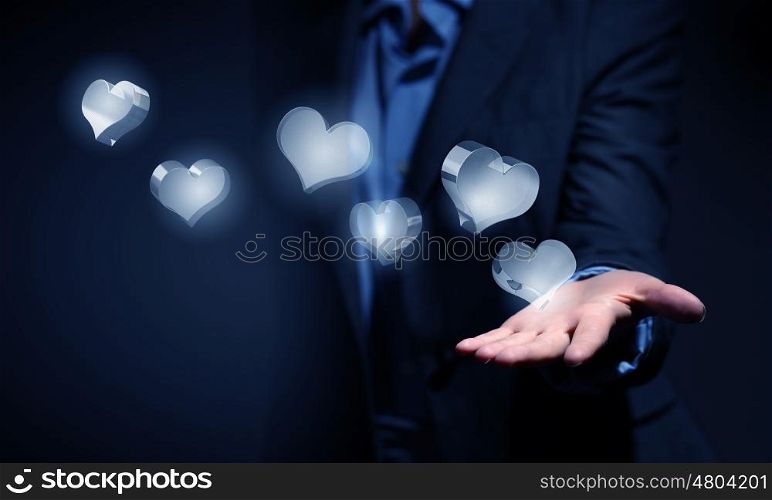 Close up of businesswoman hand holding digital icon in palm. Heart glass icons in palm