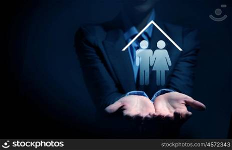 Close up of businesswoman hands holding digital icon in palm. Real estate question