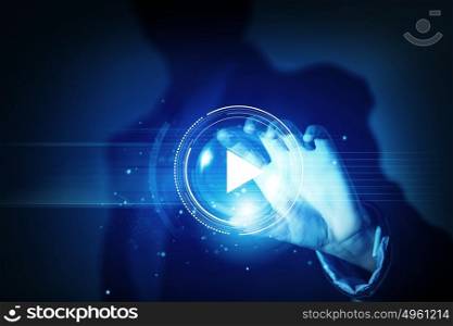 Close up of businesswoman pressing media play icon. Media technologies in our hands