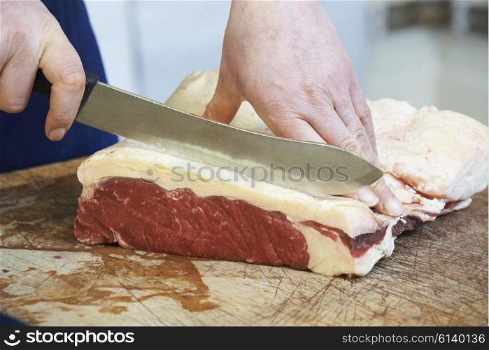 Close Up Of Butcher Preparing Sirloin Steak