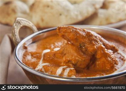 Close-up of butter chicken served in container