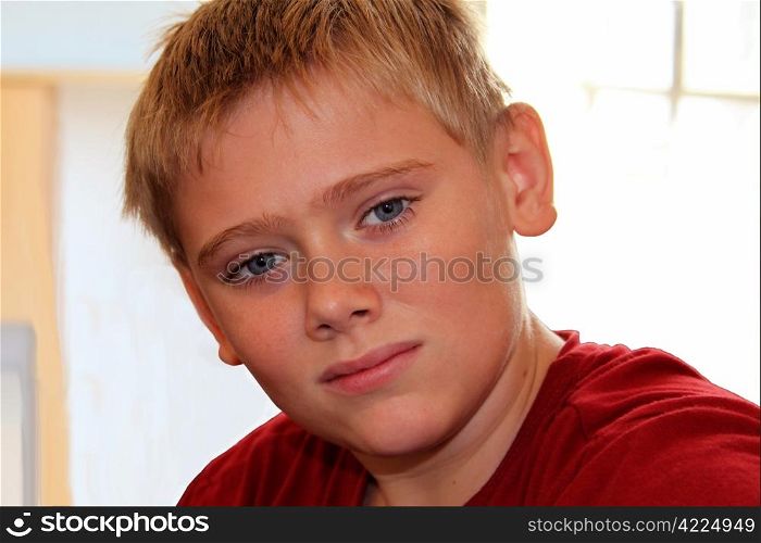 Close-up of Calm Attractive Young Blond Boy with Soft Smile