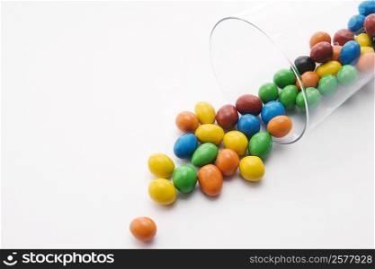 Close-up of candies spilling from a glass