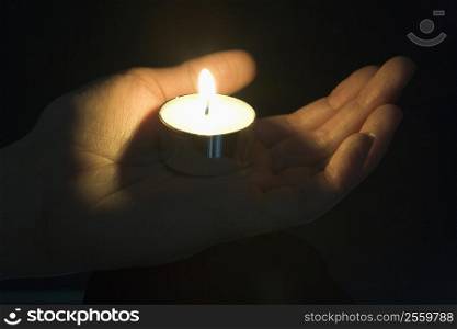 Close-Up Of Candle In The Palm Of A Persons Hand
