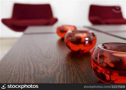 Close-up of candlestick holders in a row on a table