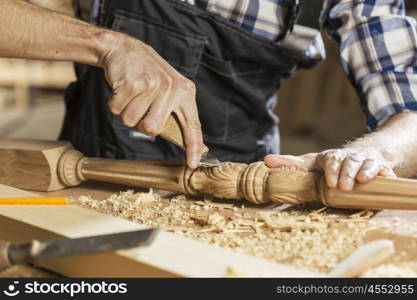 Close up of carpenter&#39;s hands working with cutter in his studio