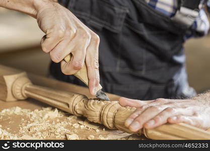 Close up of carpenter&#39;s hands working with cutter in his studio