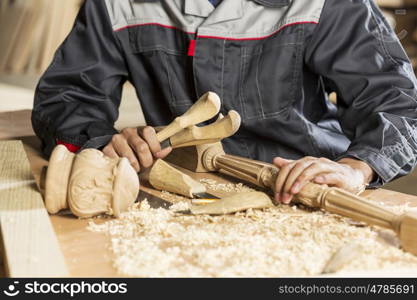 Close up of carpenter&#39;s hands working with cutter in his studio