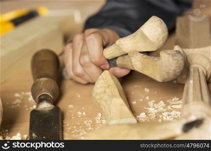 Close up of carpenter&#39;s hands working with cutter in his studio