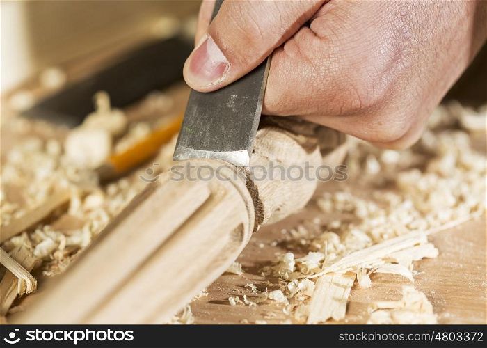 Close up of carpenter&#39;s hands working with cutter in his studio