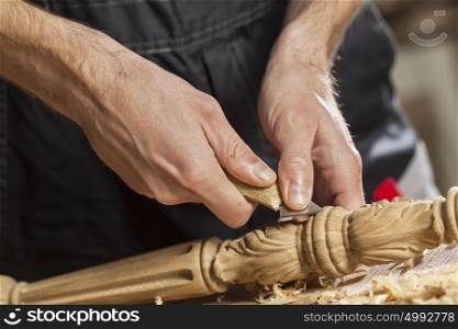 Close up of carpenter&rsquo;s hands working with cutter in his studio