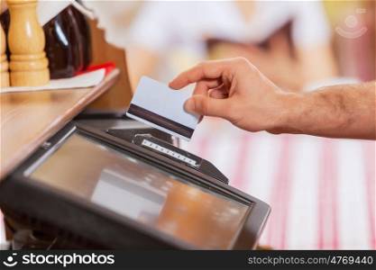 Close-up of cashier hands. Close-up image of cashier male hands holding card