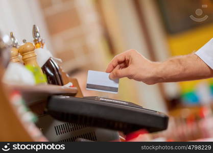 Close-up of cashier hands. Close-up image of cashier male hands holding card