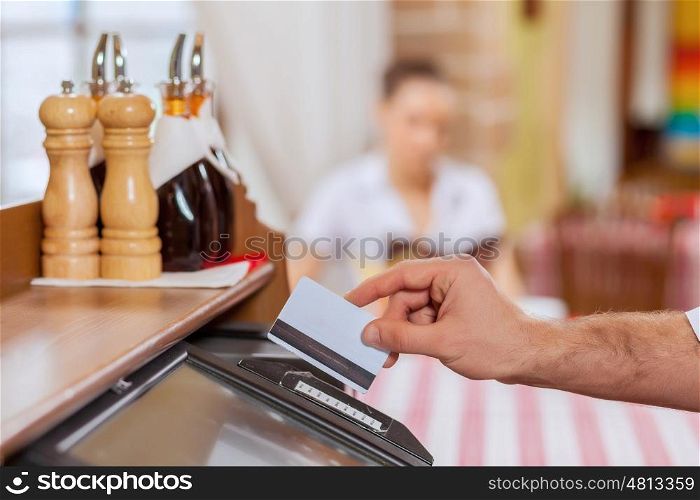 Close-up of cashier hands. Close-up image of cashier male hands holding card