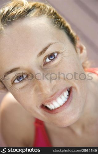 Close-up of Caucasian mid-adult woman smiling and looking at viewer.