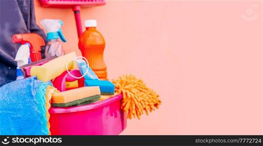 close-up of caucasian woman holding basin with cleaning supplies, spring clean concept. caucasian woman holding basin with cleaning supplies