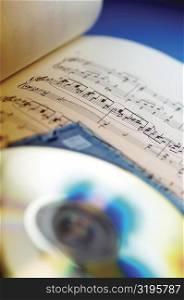 Close-up of CD and sheet music