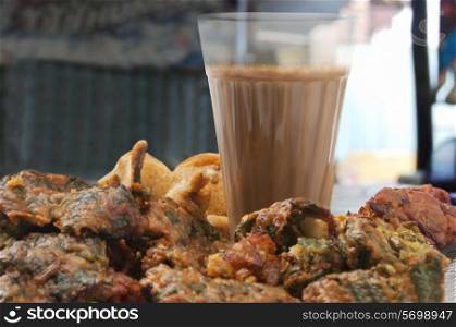 Close-up of chai with pakoras and bhajiyas