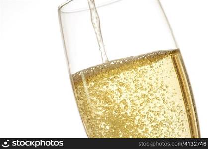 Close-up of champagne being poured into a champagne flute