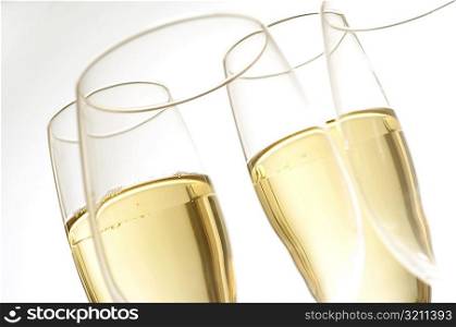 Close-up of champagne in two champagne flutes with two wineglasses