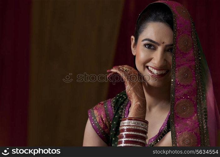 Close-up of cheerful young Indian bride