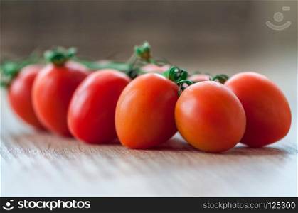 Close-up of cherry tomatoes on a wooden table. Shallow depth of field.