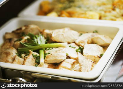 Close-up of chicken and leek in a container