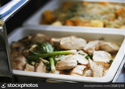 Close-up of chicken and leek in a container