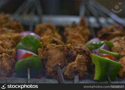 Close-up of chicken and vegetables being barbecued