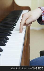 Close Up Of Child's Hands Playing Piano
