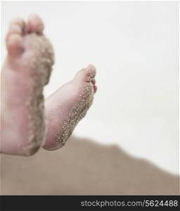Close-up of children&rsquo;s feet in the sand