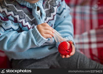 Close-up of childrens hands and Christmas tree decorations.. Childrens hands hold a Christmas tree toy 3706.