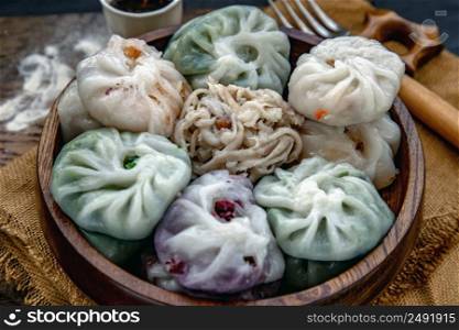Close-up of Chinese chives Dumplings Mixed Color or Garlic Chives Dim Sum Rice Cake inside with Taro Slice ,Bamboo shoot and Many kind of vegetable inside the flour, Steamed Served Sweet Black Soy Sauce Chinese Food Style side view, Chinese Food Appetizer dish Style.