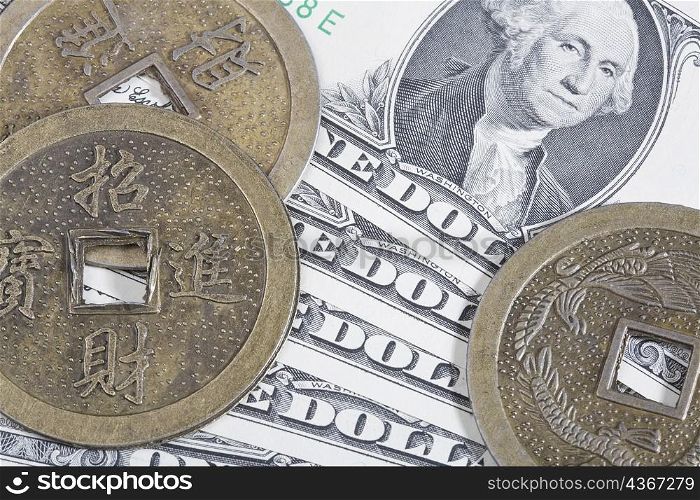 Close-up of Chinese coins on paper currency