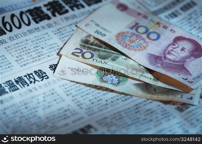 Close-up of Chinese currency on a newspaper