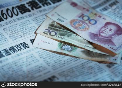 Close-up of Chinese currency on a newspaper