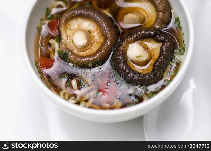 Close-up of Chinese soup with mushrooms in a bowl