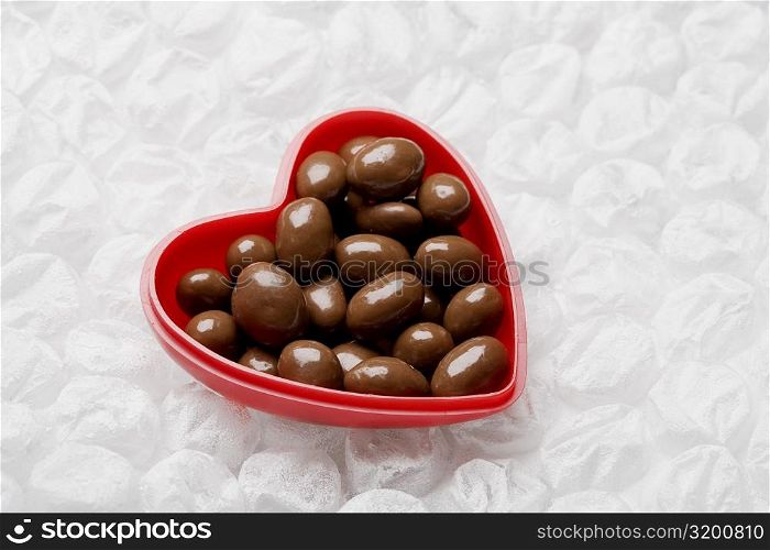 Close-up of chocolates in a heart shaped container