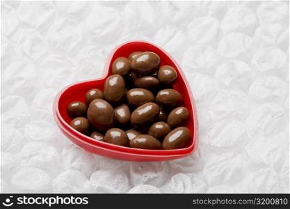 Close-up of chocolates in a heart shaped container