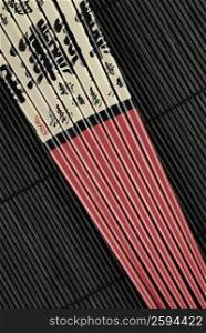 Close-up of chopsticks on a mat