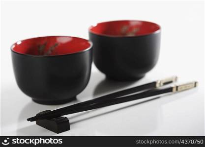 Close-up of chopsticks with two bowls