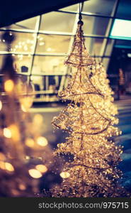 Close up of Christmas decoration lighting in front of a shopping mall, defocused