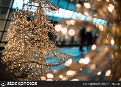 Close up of Christmas decoration lighting in front of a shopping mall, defocused