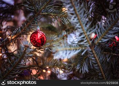 Close up of Christmas decoration on the Christmas market. Christmas bauble on a fir branch.