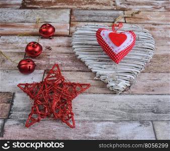 Close-up of Christmas decoration on wooden surface - star, heart and balls.