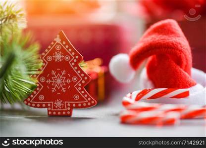 Close up of Christmas holiday background with Santa hat and decorations candy cane pine tree gift box and Festive Happy New Year object