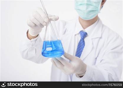 close up of cientist is testing and researching some blue liquid chemical in laboratory isolated white background.