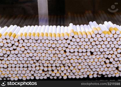 Close-up of cigarettes on an assembly line at a factory, Phillip Morris Factory, Richmond, Virginia, USA